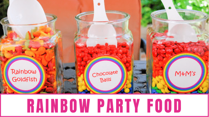 Large jars of rainbow goldfish, chocolate balls, and M&Ms are the perfect rainbow theme party ideas 